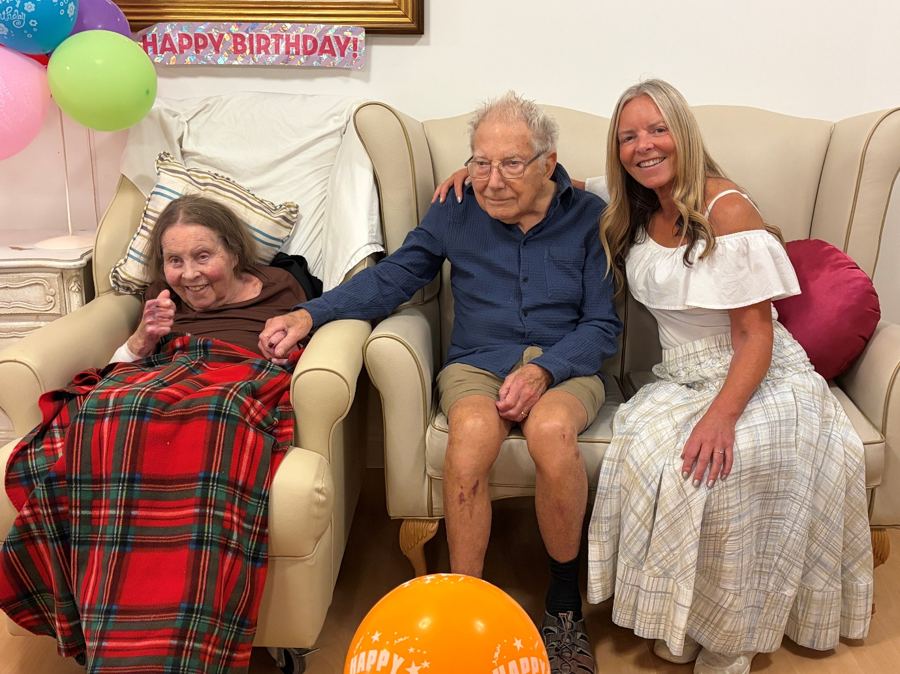Rachel with her parents at a birthday celebration